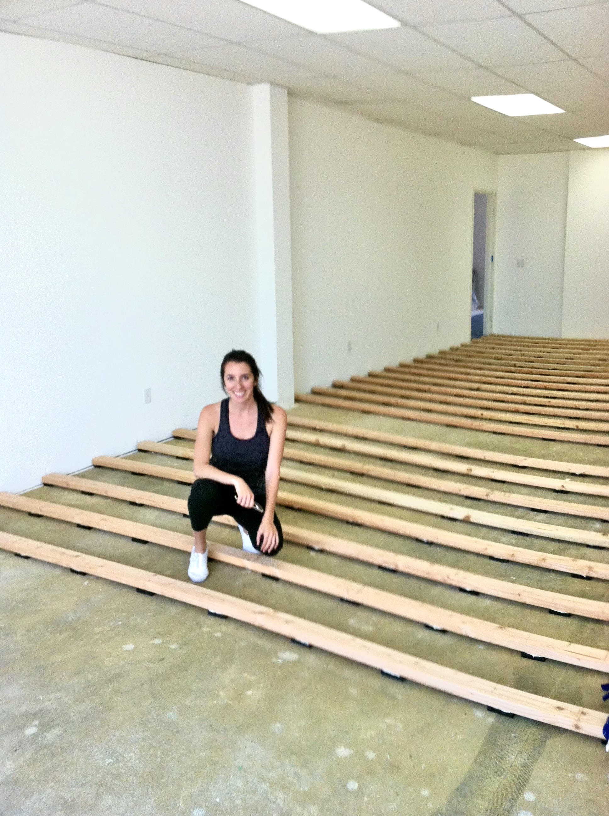Mel in the new studio space during floor installation